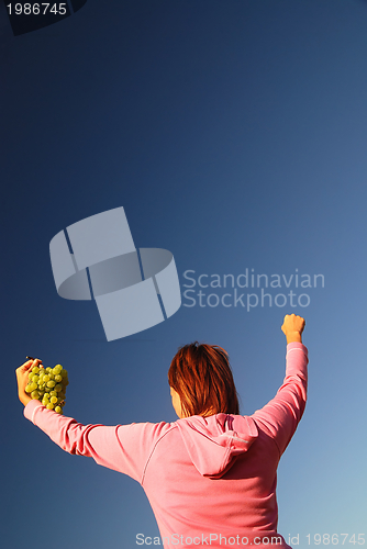 Image of girl with grape outdoor