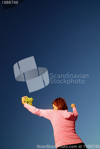 Image of girl with grape outdoor