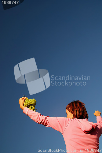 Image of girl with grape outdoor