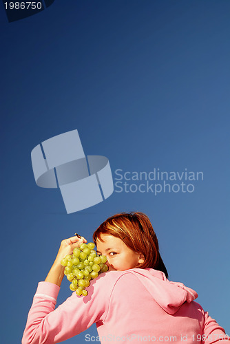 Image of girl with grape outdoor