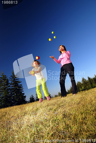 Image of Food balancing concept with girls in nature