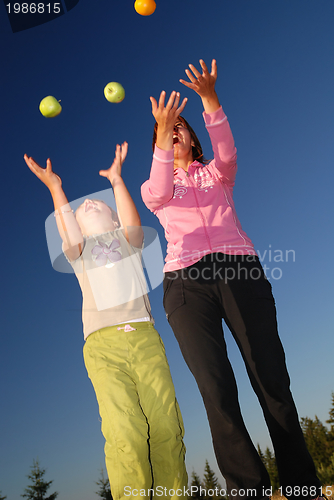 Image of Food balancing concept with girls in nature