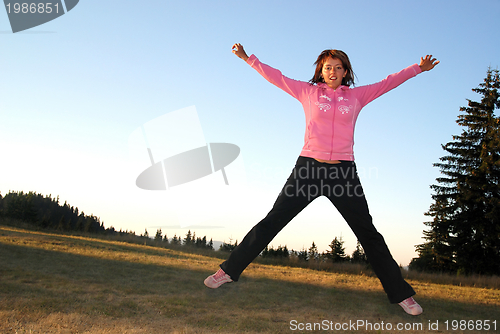 Image of pretty girl jumping in a air 
