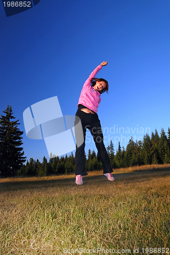 Image of pretty girl jumping in a air 