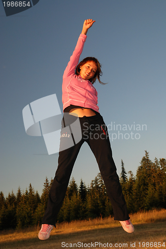 Image of pretty girl jumping in a air 