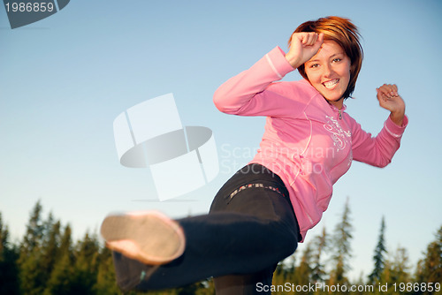 Image of pretty girl doing exercise in nature