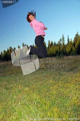 Image of pretty girl jumping in a air 