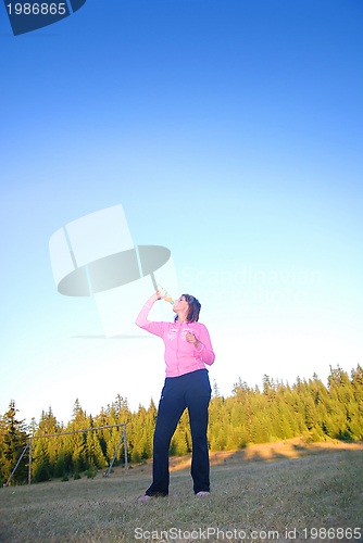 Image of young woman drinking water