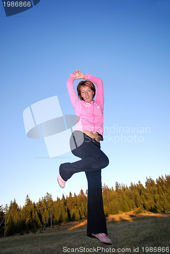 Image of pretty girl jumping in a air 