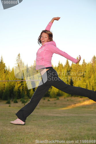 Image of pretty girl jumping in a air 