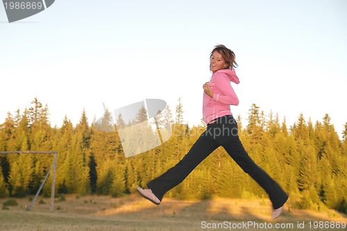 Image of pretty girl jumping in a air 