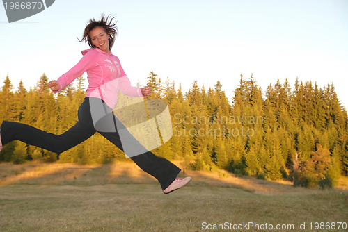 Image of pretty girl jumping in a air 