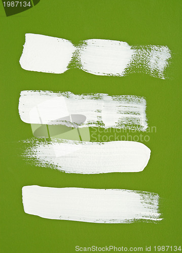 Image of White brush strokes on green background