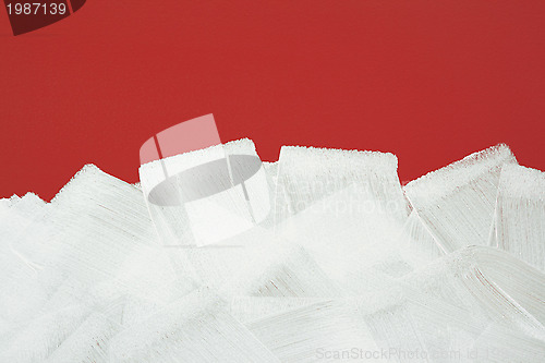 Image of Red wall painted in white with paint roller