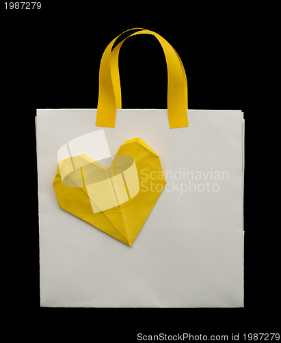 Image of White shopping bag with yellow heart.