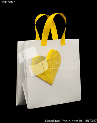 Image of White shopping bag with yellow heart.