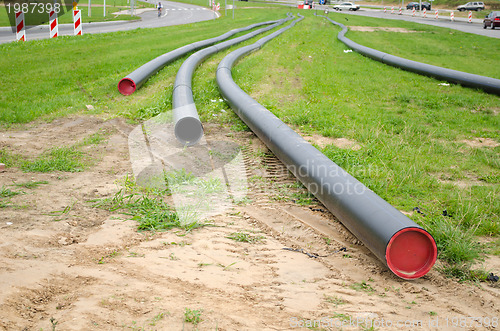 Image of electricity cable wire protective tube on meadow 