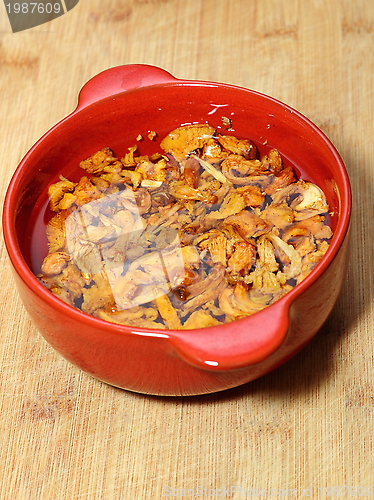 Image of yellow mushrooms in red bowl