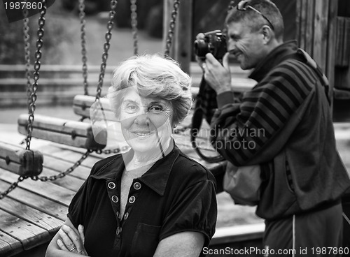 Image of Senior Woman at the Park with photographer on background