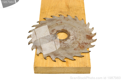 Image of circular saw disk on wood board closeup on white 