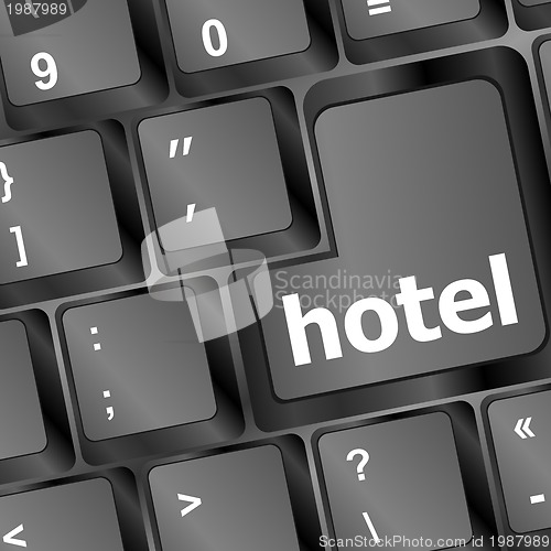 Image of Hotel key in place of enter key - business concept