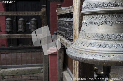 Image of bell and prayer wheels in nepal