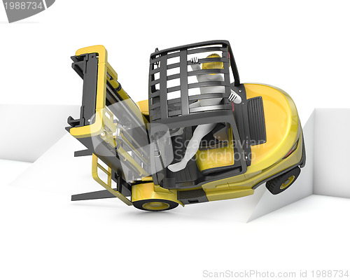 Image of Yellow fork lift truck falling after turning on slope