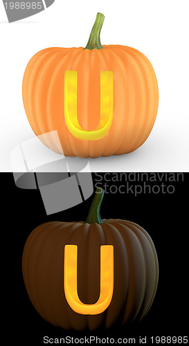 Image of U letter carved on pumpkin jack lantern