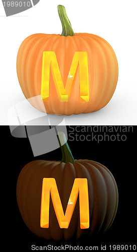 Image of M letter carved on pumpkin jack lantern