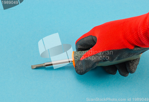 Image of hand with orange gloves hold screwdriver on blue 