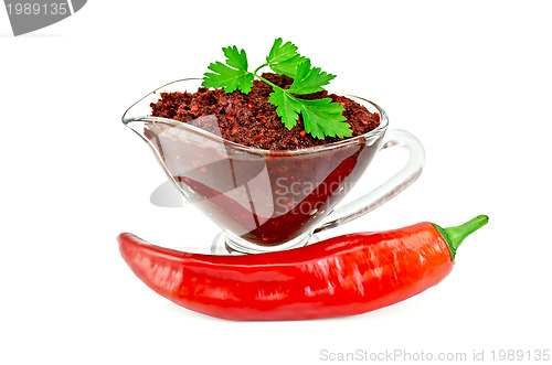 Image of Ajika in a glass gravy boat with hot pepper
