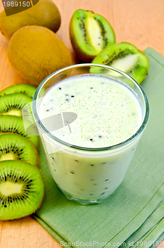 Image of Milk cocktail with kiwi on a napkin