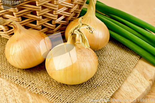 Image of Onions yellow with a bundle of green onions