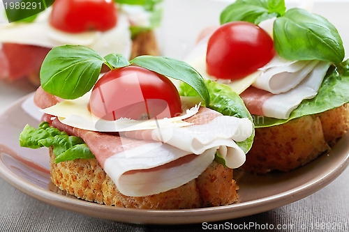 Image of Sandwich with prosciutto, parmesan cheese and tomato