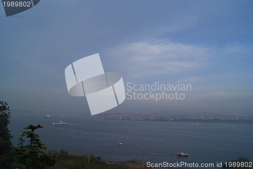 Image of Bosporus in mist with passenger ships far away