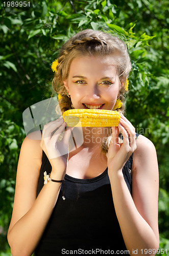 Image of woman eating corn-cob