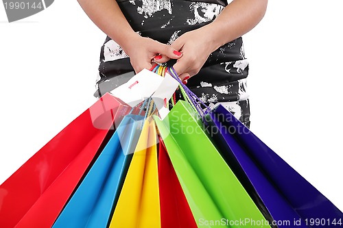 Image of woman hands holding shopping bags isolated on white. Focus on ha