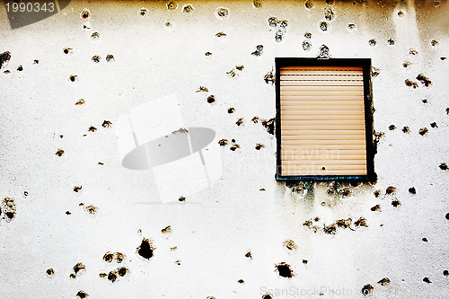 Image of Bullet holes in a house facade