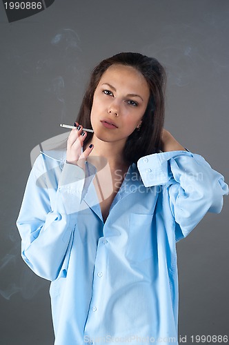 Image of beautiful young brunette woman with cigarette
