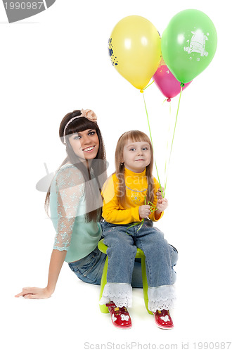 Image of studio shot of mother and daughter with balloons