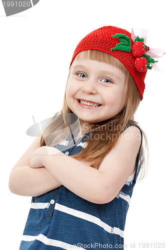 Image of beautiful little girl in a red hat with a pattern of strawberrie