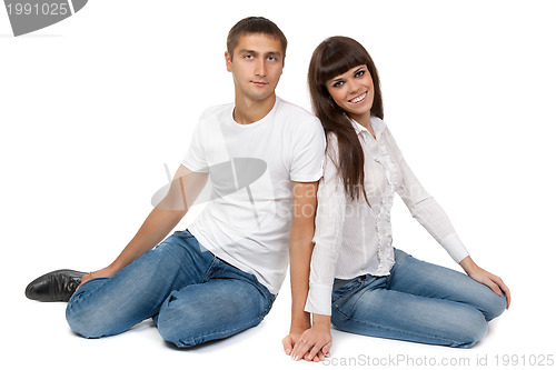 Image of Romantic young couple sitting on floor