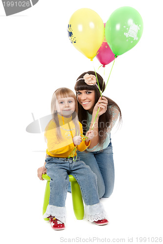 Image of studio shot of mother and daughter with balloons
