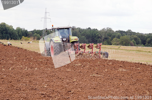 Image of tractor plow autumn field stork birds 