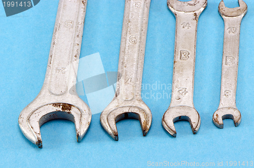 Image of set size wrench screw tools on blue 