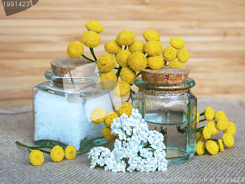 Image of Bottles of essential oil and sea salt in spa composition