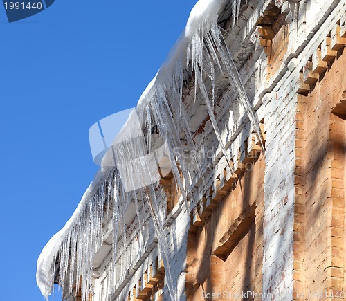 Image of Snow-covered roof with icicles