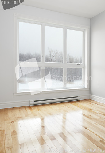 Image of Empty room and winter landscape seen through the window