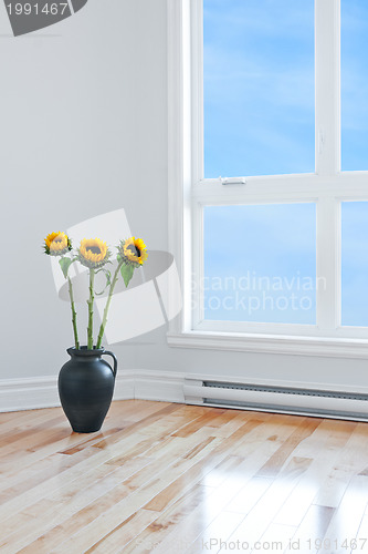 Image of Sunflowers in empty room with big window