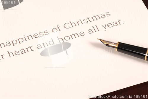 Image of Christmas card waiting to be signed by a fountain pen